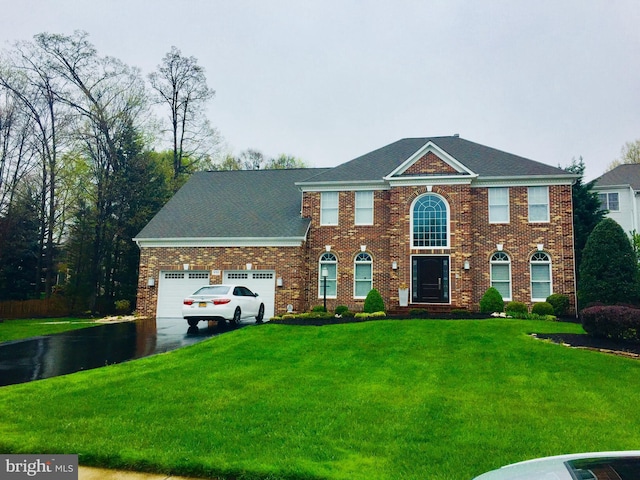 view of front of home with a garage and a front yard