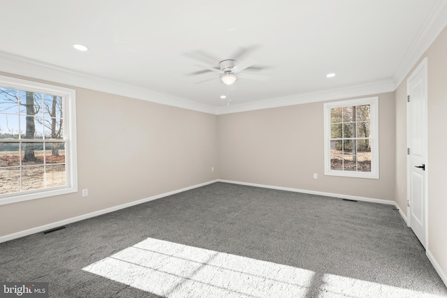 unfurnished room with ceiling fan, dark carpet, and ornamental molding