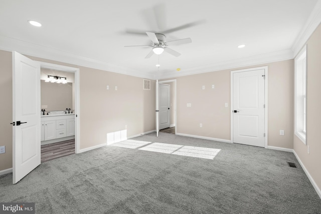 unfurnished bedroom with connected bathroom, light colored carpet, ceiling fan, and ornamental molding