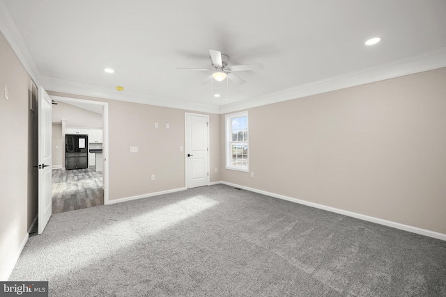 unfurnished bedroom with carpet, ceiling fan, black refrigerator, and crown molding