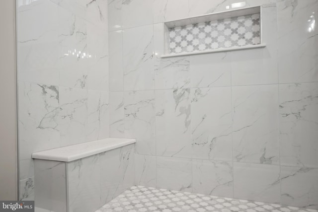 bathroom with a tile shower