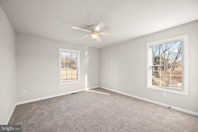 carpeted empty room featuring ceiling fan