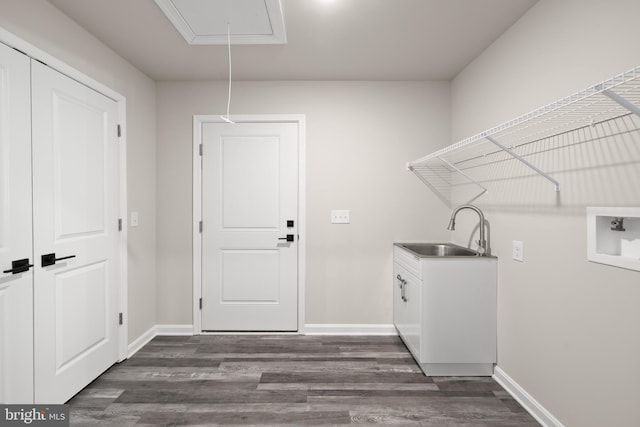 clothes washing area with dark wood-type flooring, sink, cabinets, and hookup for a washing machine