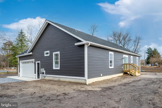 view of side of property featuring a garage