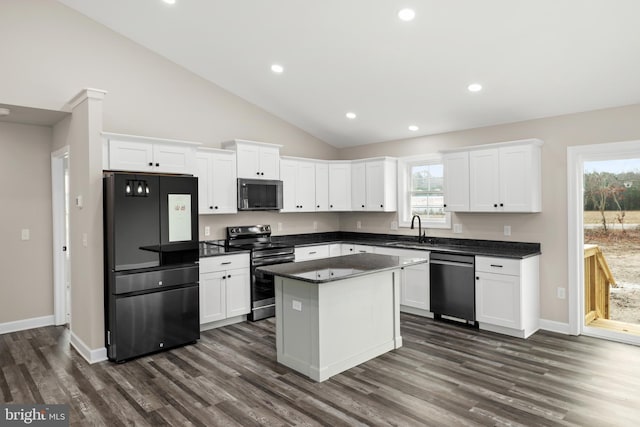 kitchen with appliances with stainless steel finishes, white cabinetry, and sink