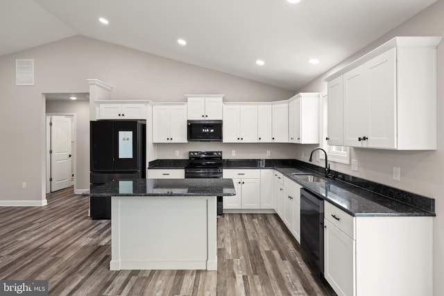 kitchen featuring black appliances, white cabinets, sink, and dark stone counters