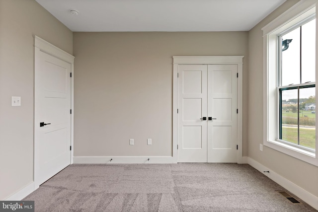 unfurnished bedroom with light colored carpet