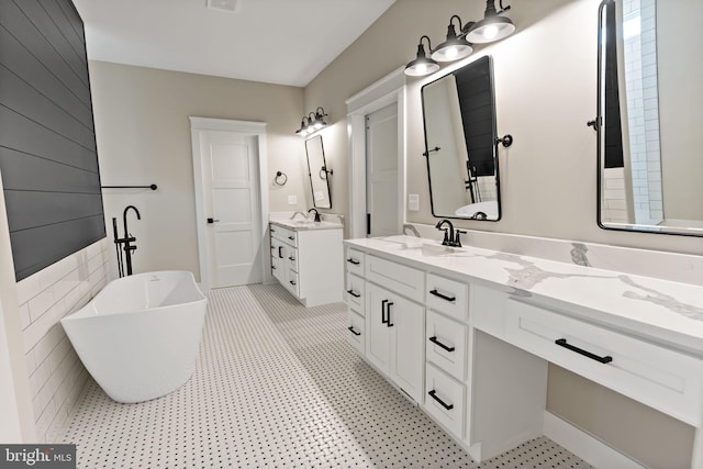 bathroom with vanity and a tub to relax in