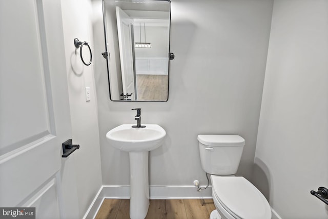 bathroom featuring hardwood / wood-style floors and toilet