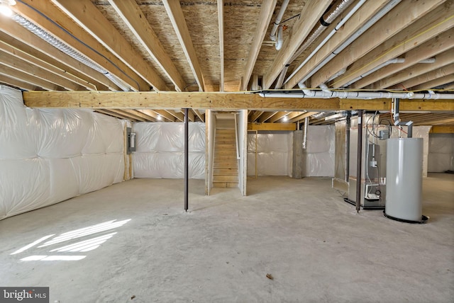 basement with water heater, heating unit, and electric panel