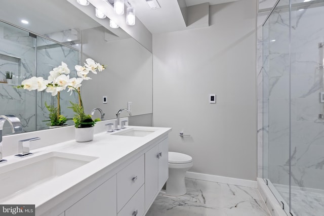 bathroom featuring a shower with door, vanity, and toilet