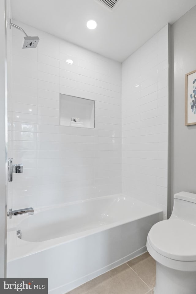 bathroom featuring tile patterned floors, bathtub / shower combination, and toilet