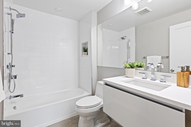 full bathroom with tile patterned floors, vanity, toilet, and tiled shower / bath