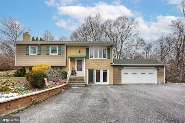 raised ranch with french doors and a garage