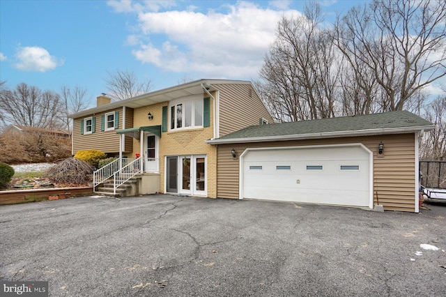 bi-level home with french doors and a garage