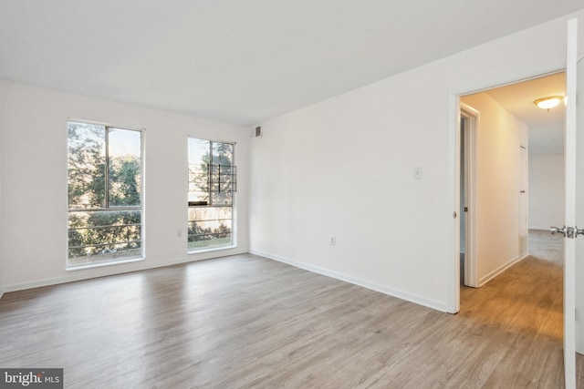 spare room featuring light hardwood / wood-style floors