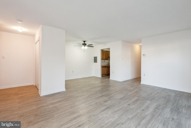 unfurnished living room with ceiling fan and light hardwood / wood-style floors