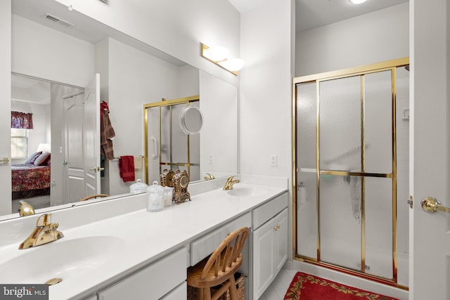 bathroom featuring vanity, a shower with shower door, and tile patterned floors