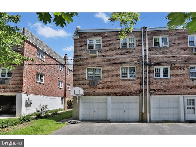 rear view of house featuring a garage