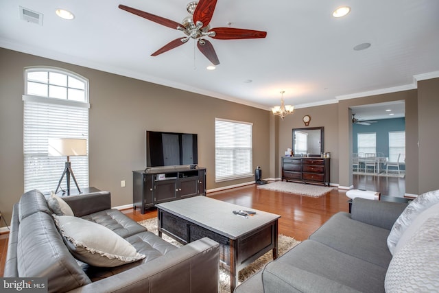 living room with ceiling fan with notable chandelier, crown molding, and light hardwood / wood-style flooring