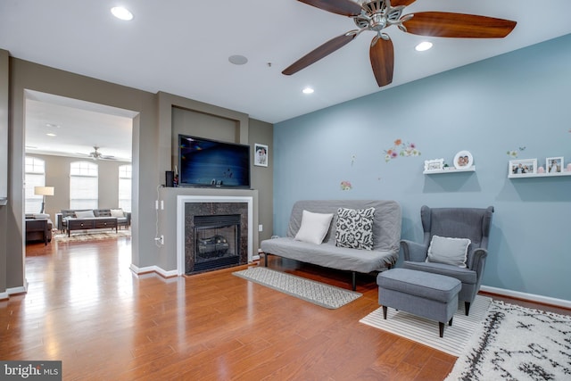 living room with hardwood / wood-style floors and ceiling fan