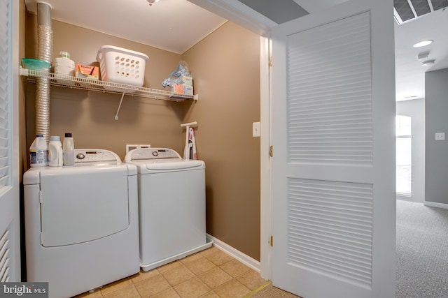 laundry room featuring separate washer and dryer and light colored carpet