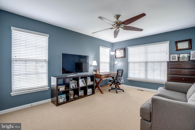 office area with carpet, plenty of natural light, and ceiling fan