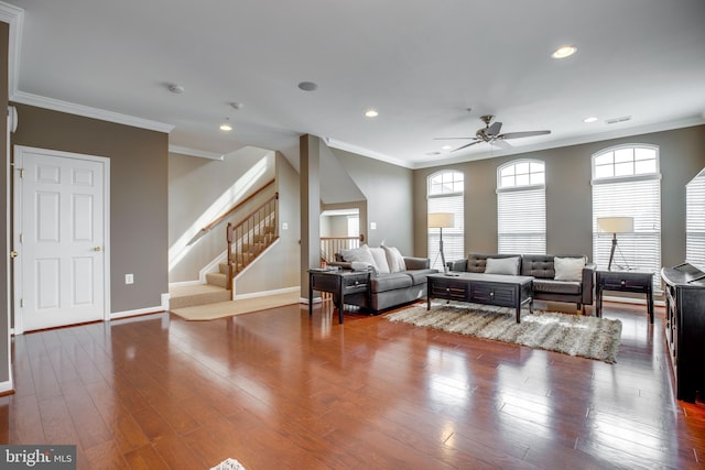 living room with crown molding, ceiling fan, and wood-type flooring