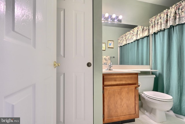 bathroom with tile patterned flooring, vanity, toilet, and walk in shower