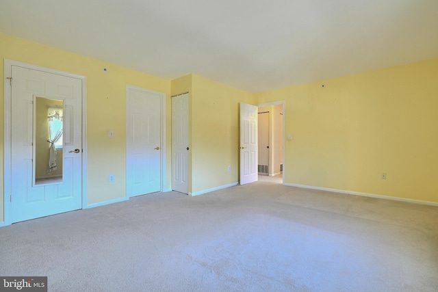 unfurnished bedroom featuring light colored carpet