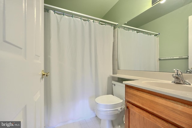 bathroom with curtained shower, tile patterned flooring, vanity, and toilet