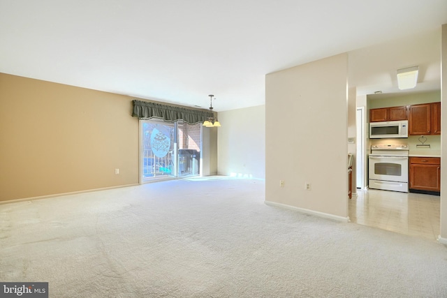 unfurnished living room featuring light colored carpet and an inviting chandelier