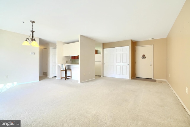 unfurnished living room featuring light carpet