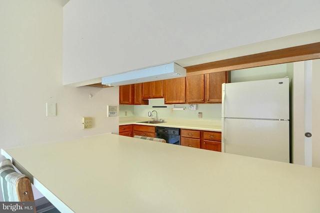 kitchen featuring kitchen peninsula, white refrigerator, dishwasher, and sink