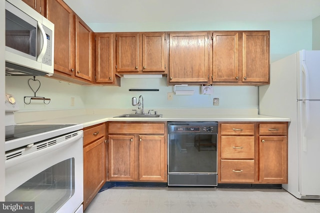 kitchen featuring sink and white appliances