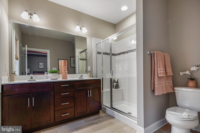 bathroom with vanity, toilet, and walk in shower