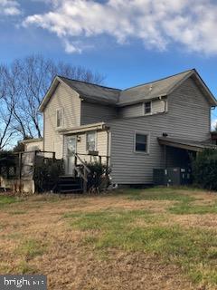 back of property featuring a lawn