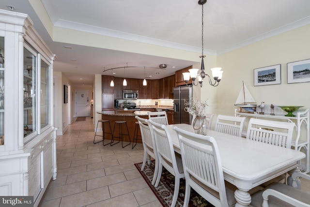 dining room with light tile patterned floors, crown molding, and an inviting chandelier