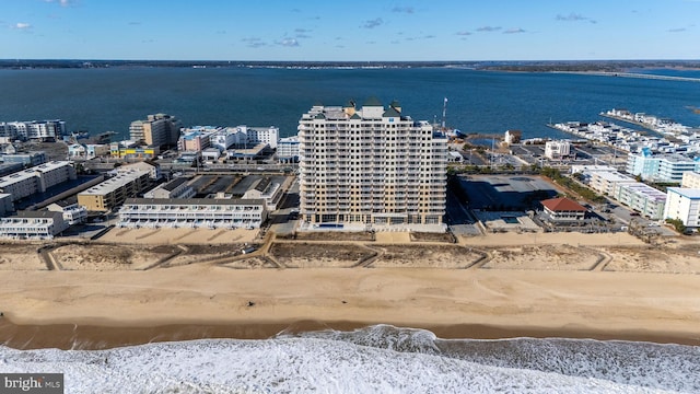 birds eye view of property with a water view and a view of the beach