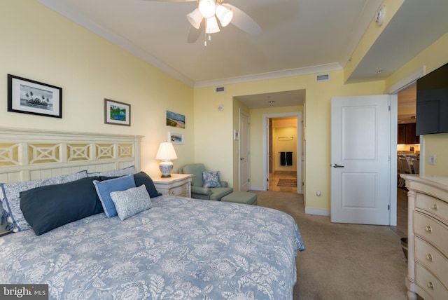 carpeted bedroom featuring ceiling fan and ornamental molding