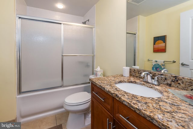 full bathroom featuring tile patterned flooring, vanity, toilet, and enclosed tub / shower combo