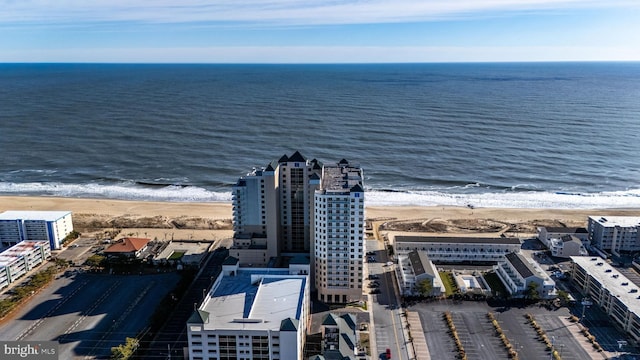 drone / aerial view featuring a water view and a beach view