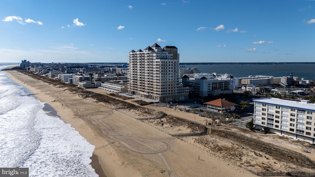 bird's eye view featuring a view of the beach and a water view