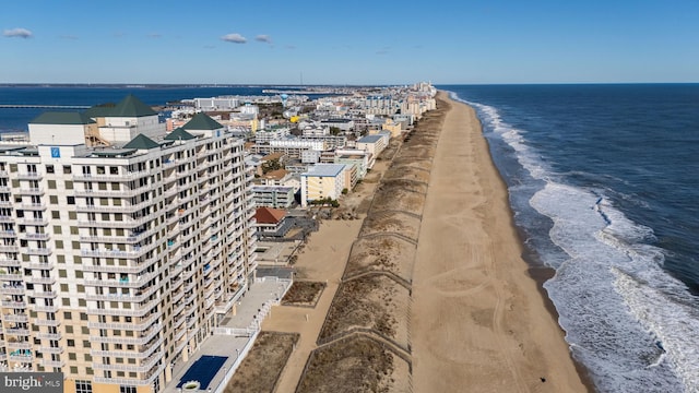 birds eye view of property featuring a water view and a beach view