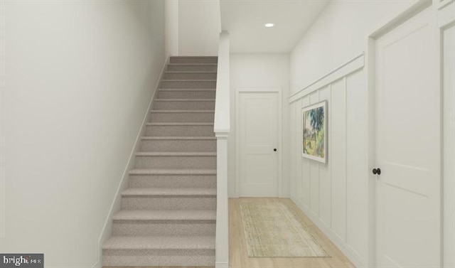 stairs with hardwood / wood-style flooring