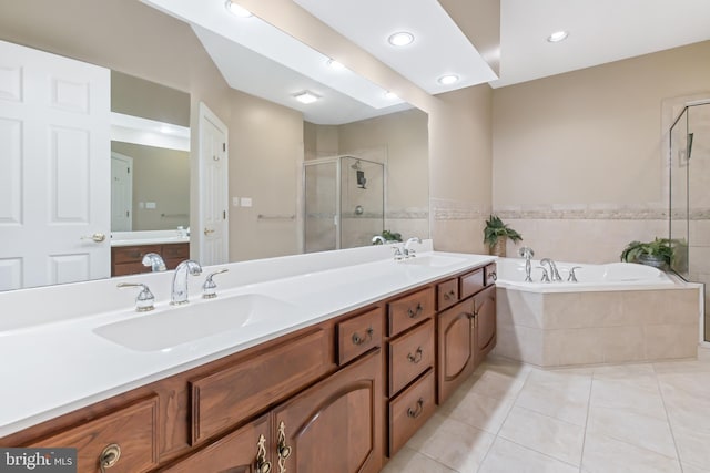 bathroom featuring tile patterned flooring, shower with separate bathtub, and vanity