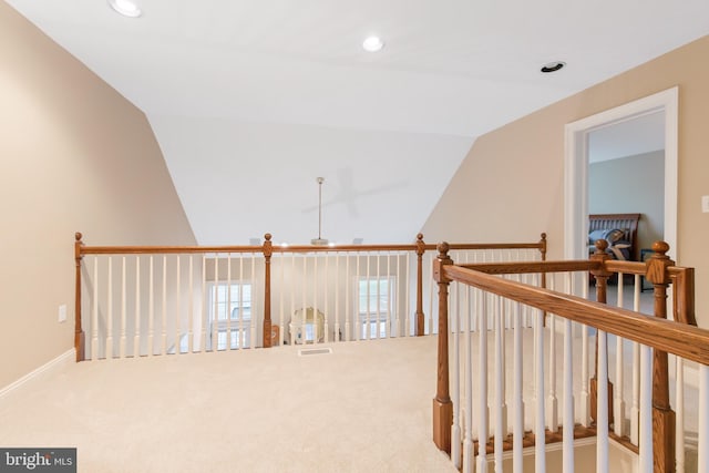 corridor with carpet flooring and lofted ceiling