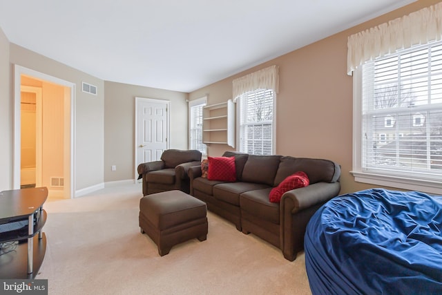 living room featuring light carpet and plenty of natural light