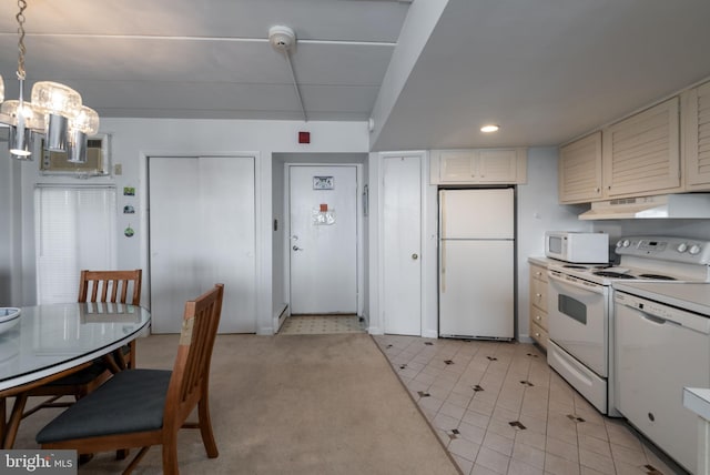 kitchen featuring white appliances, white cabinets, decorative light fixtures, light tile patterned floors, and a notable chandelier