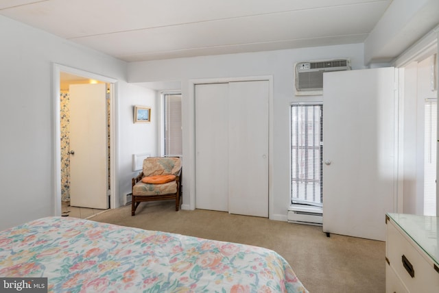 carpeted bedroom with a wall unit AC and a baseboard radiator